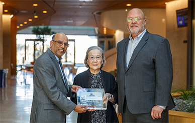 Farhat Beg, left, receives a Shao-Chi and Lily Lin Chancellor’s Endowed Chair in Engineering Science plaque from Lily Lin and George Tynan